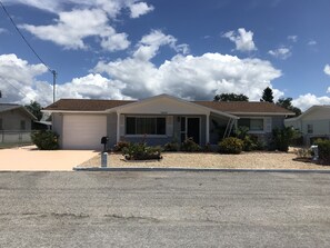 Extended driveway alongside garage and street space for boat or extra vehicles.