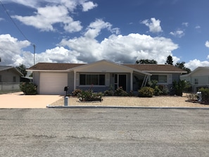 Extended driveway alongside garage and street space for boat or extra vehicles.