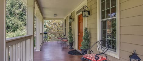 The covered porch is a perfect place to relax and enjoy the breeze.
