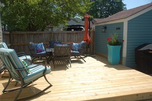 The front patio has seating for six, an offset umbrella and outdoor grill.