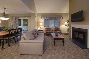 Relax and rejuvenate in the cozy living room with a fireplace.