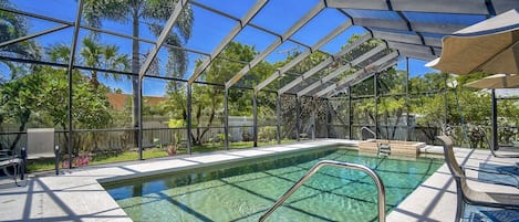 Screened-in, heated pool with outdoor dining and lounge area!