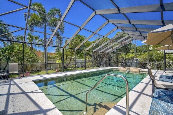 Screened-in, heated pool with outdoor dining and lounge area!