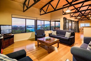 Floor-to-ceiling windows frame the bay, bringing the ocean right into your living space.