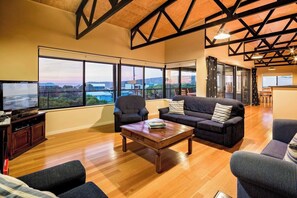 Floor-to-ceiling windows frame the bay, bringing the ocean right into your living space.