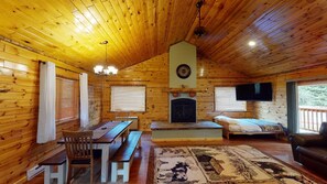 Upon entrance you are greeted by the dining table and living room. Living room also includes a Futon with a Full bed.