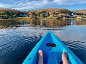 The still water of the bay looking back to house from a kayak