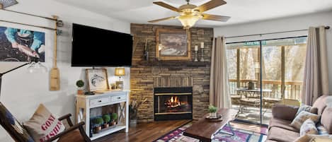 Bright & Clean Living Room has electric fireplace and views of the lake. 