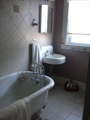 Old style bathtub in one of the 3 bathrooms.  