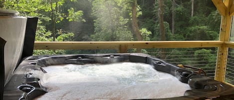 European hot tub overlooking waterfall, complete with six (6) with high top chairs & plush spa towels