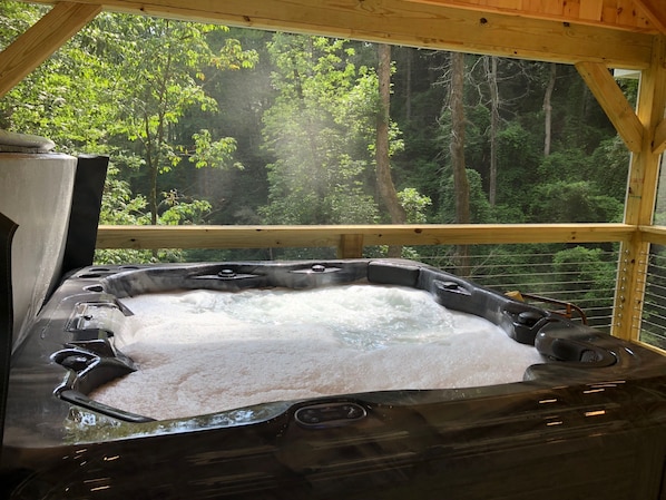 European hot tub overlooking waterfall, complete with six (6) with high top chairs & plush spa towels