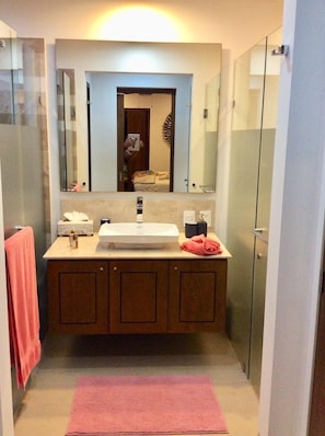 Bathroom with a door to the master bedroom and a second to the hallway