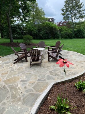 Stone patio, 6 Adirondack chairs, and propane gas firepit