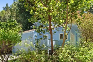 The home has a lush garden and surrounded - by beautiful trees.