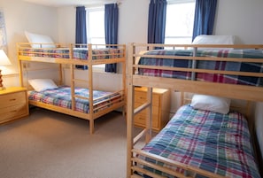 The three bedrooms feature a variety of bedding options.