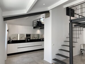 Upper floor, fully equipped kitchen, dining area, bathroom and loft relax area