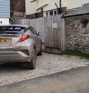 The car park space, big enough for 2 standard sized family saloons. 