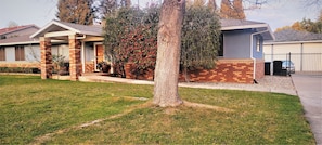 Front of main house with partial view of Detached Garage where suite is located