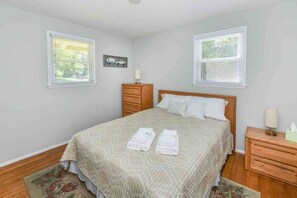 Queen Bedroom with chest of drawers, night stand and closet with extra hangers. 