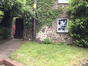 Side view of Coach cottage and gate to walled garden