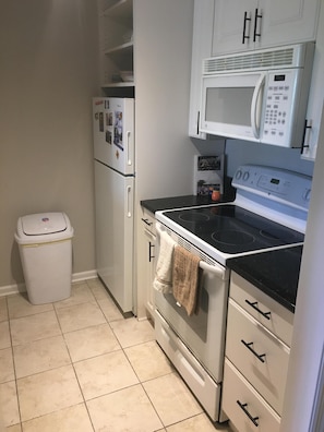 Kitchen with microwave, stove, and refrigerator