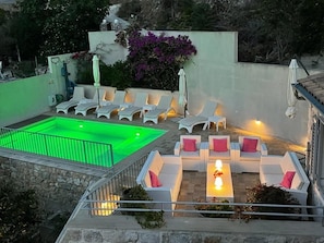 At dusk our automatic system lights the pool in colour + turns on wall lights

