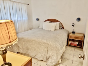 The master bedroom with dresser and closet.