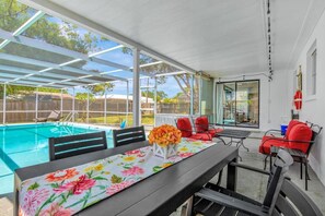 Covered poolside dining and seating area.