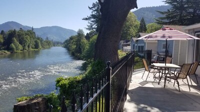 The common patio overlooks the Rogue River. The patio also includes a fire pit!