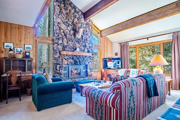 Relax by the fireplace in this sun-filled living room!