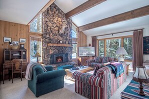 Relax by the fireplace in this sun-filled living room!