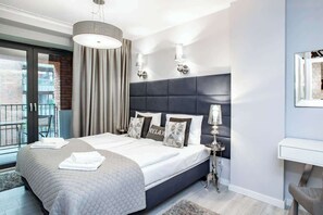 Spacious and elegant bedroom with comfortable double bed and desk for remote work during business trips.
