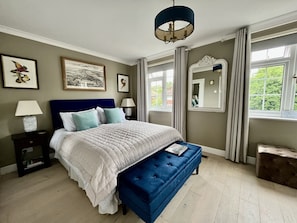 Guest bedroom with ensuite bathroom and kingsize bed with orthopaedic mattress