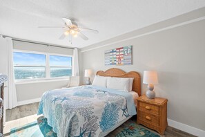 Beautiful bedroom with serene coastal décor and plenty of natural light