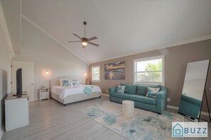 This primary bedroom offers the perfect escape, featuring a king bed, additional sofa bed, workspace, and the luxury of ensuite bathroom.