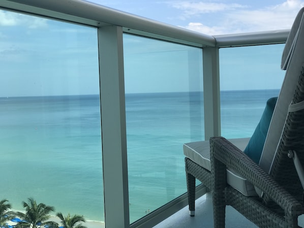 Relax on your chaise and enjoy the view of the ocean from your private balcony