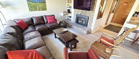 Living area with gas fireplace and TV.