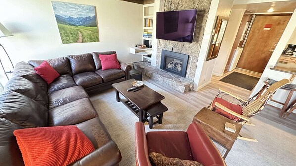 Living area with gas fireplace and TV.