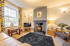 Samphire Cottage, Brancaster Staithe: Sitting room featuring a wood burning stove