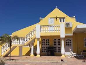 Back of Property showing stairs and door leading to private studio apartment