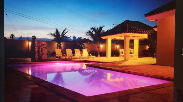 Private pool with different changing lights in the backyard 