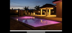 Backyard at night time with gazebo 