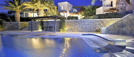 The villa and pool at night