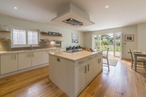 Ground floor: Open plan kitchen/diner with french doors to patio and garden