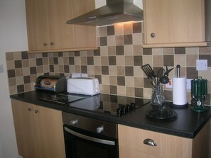 Kitchen with Dishwasher, microwave and Cooker.