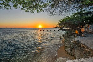 Witness the perfect sunset while lounging in beach chairs.