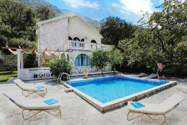 Pool deck area with dining area and sun loungers