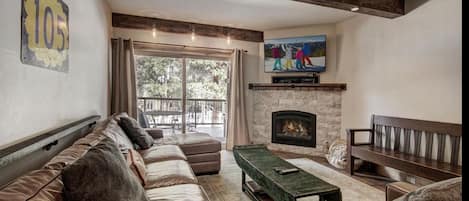 Living Room area with extra large couch, balcony and open to kitchen