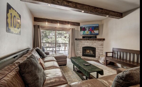 Living Room area with extra large couch, balcony and open to kitchen