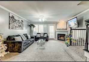 Opulent Living Room equipped with ROKU Television, Fireplace, and Sofa Sleeper. 